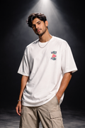 Man wearing a white t-shirt with a colorful logo on a dark background